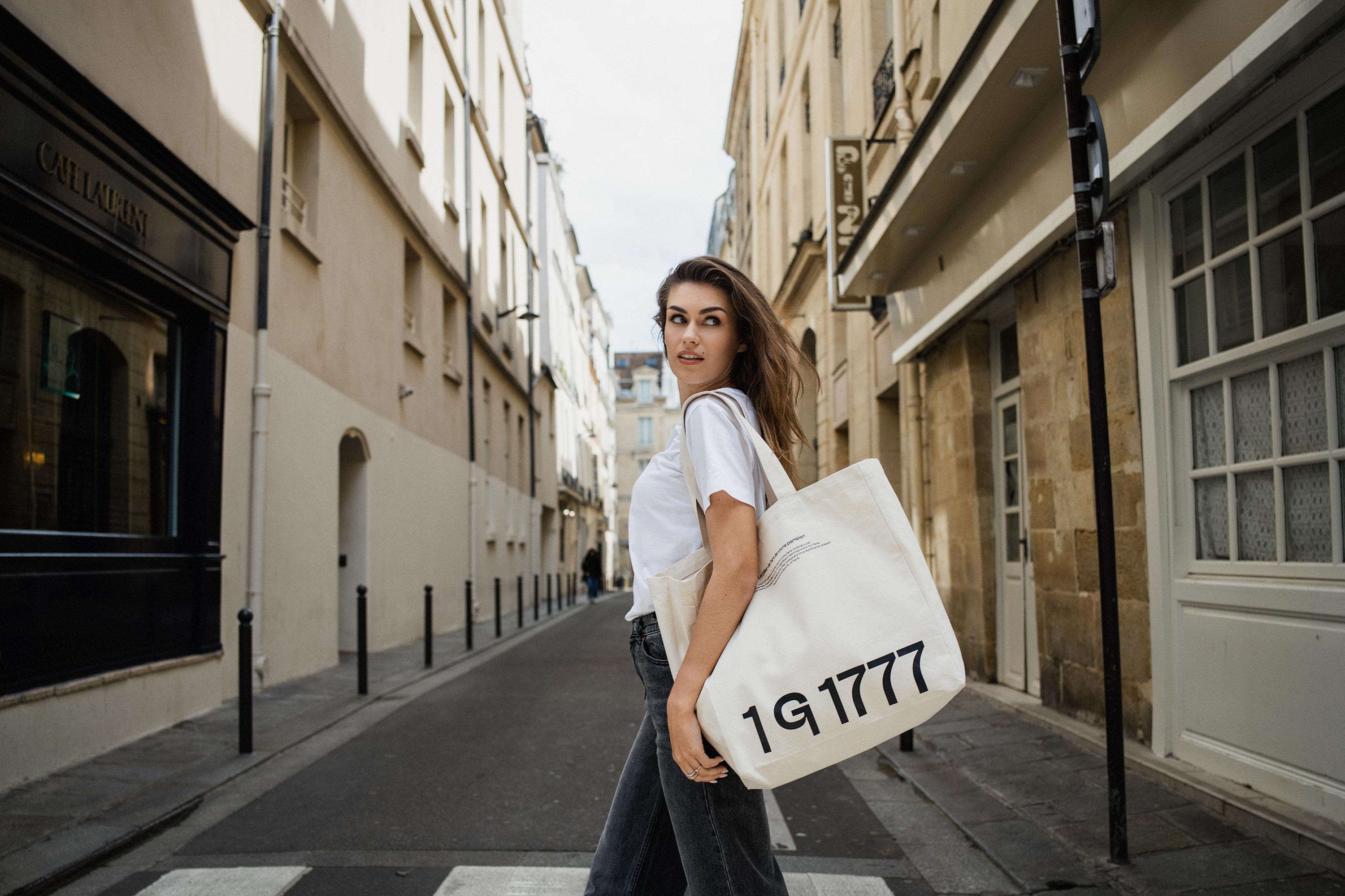 Model wearing Rosenstaub's 1G1777 Canvas Tote Bag while crossing a street in Paris